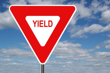 Yield sign w pleasant clouds